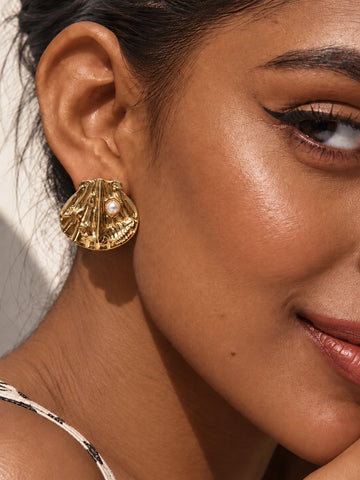 Niska gold-tone shell Resin pearl stud earring worn by model
