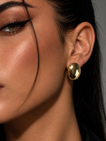 Niska gold-tone oval dome stud earring model close-up