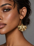 Niska gold-tone ginkgo leaf Resin drop earring worn by model