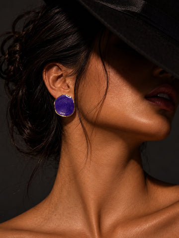Model wearing Niska purple spiral statement stud earring