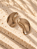 Gold tone sculptural curved statement earrings