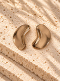 Gold tone sculptural curved statement earrings