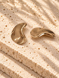 Gold tone sculptural curved statement earrings
