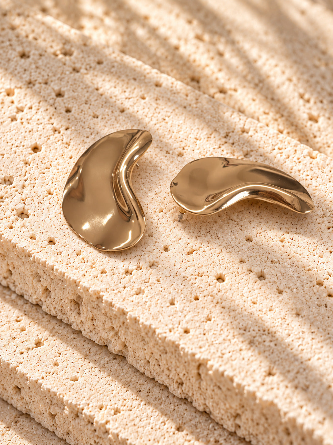 Gold tone sculptural curved statement earrings