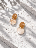 Niska honey brown and marbled Resin drop earrings on white travertine