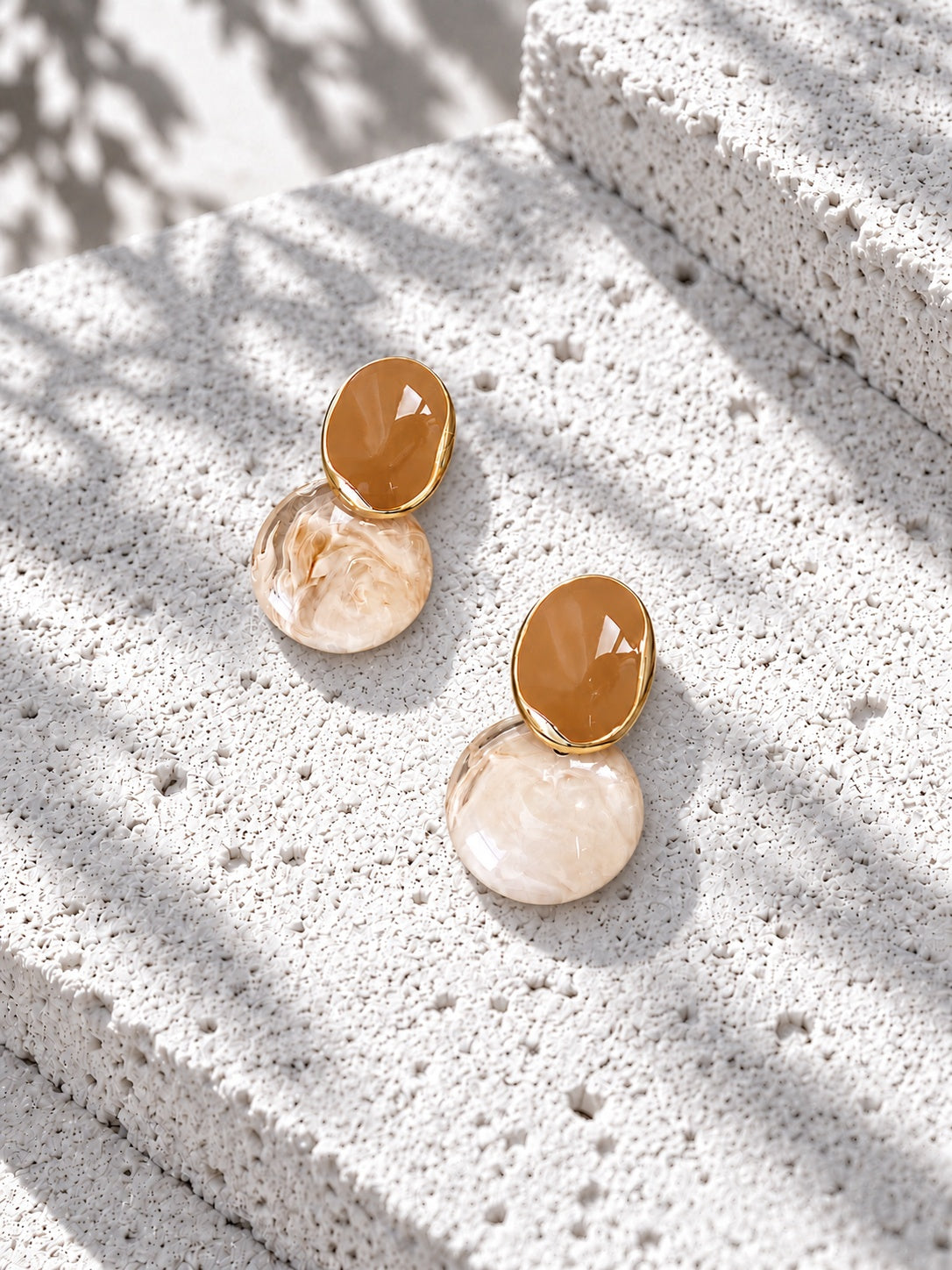 Niska honey brown and marbled Resin drop earrings on white travertine