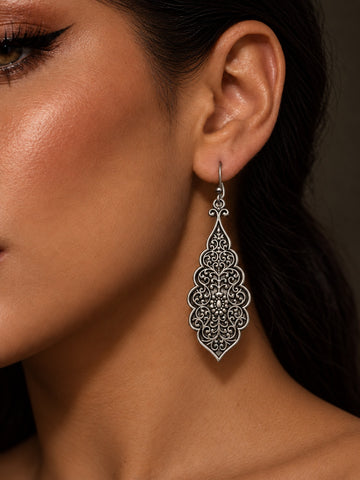 Niska Resin filigree drop earring worn on model