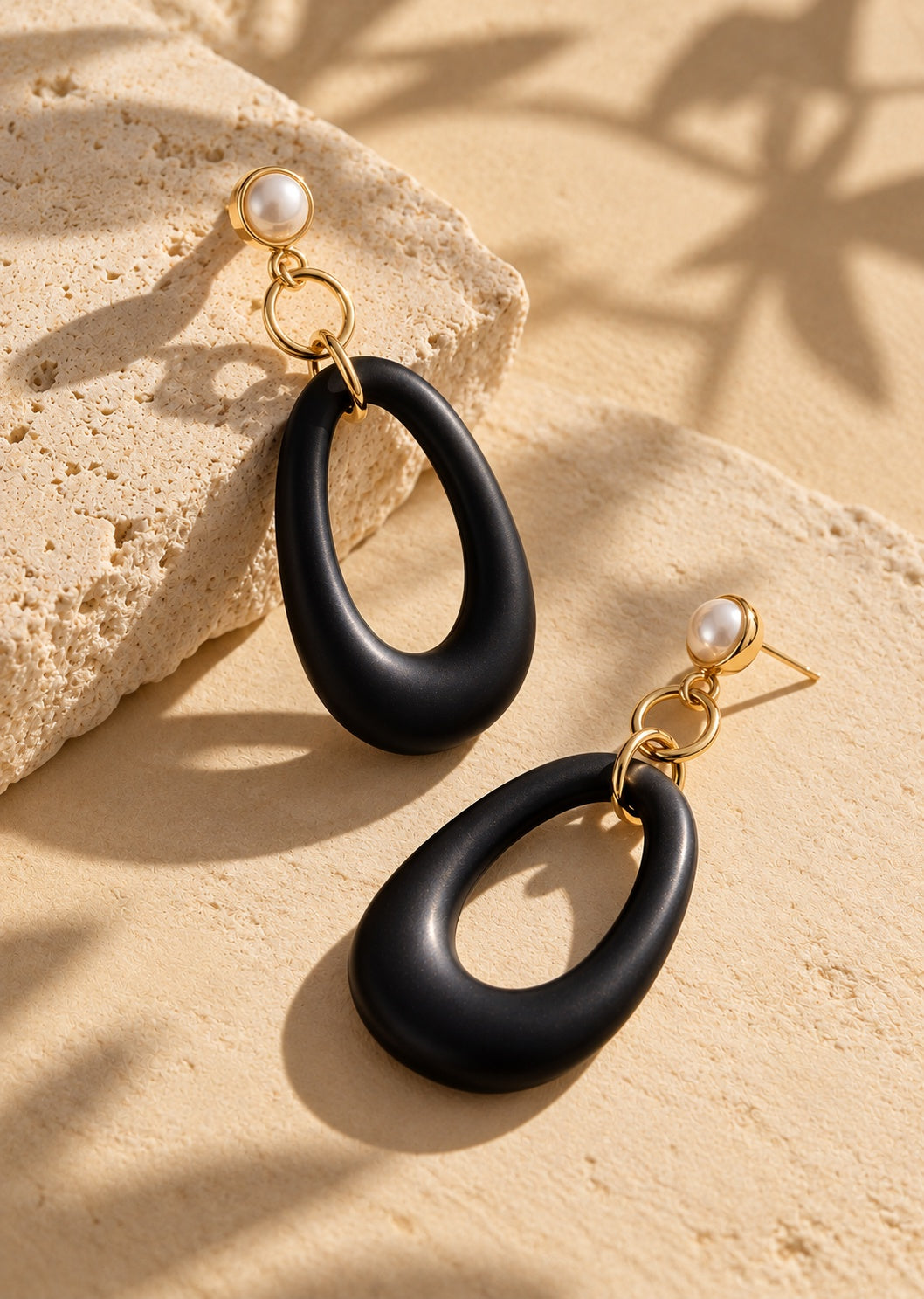 Black resin long earrings overhead angle