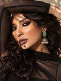 Model wearing Monalisa green stone oxidized jhumka earrings