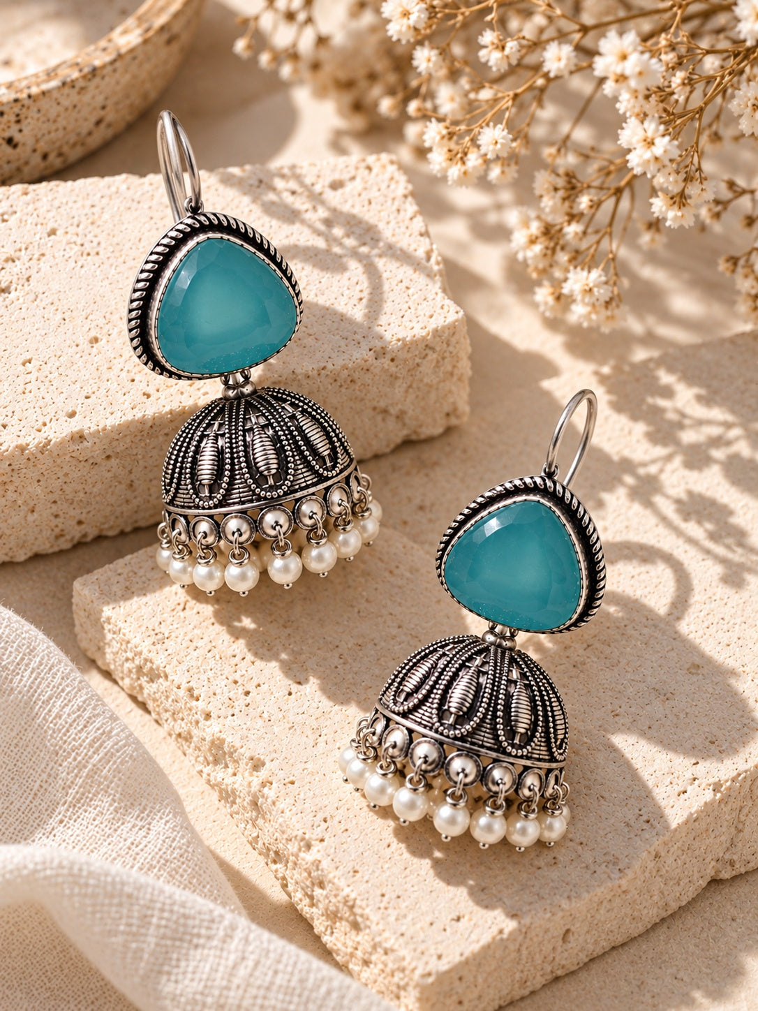 ER26N10356 Monalisa Stone Silver Replica Jhumka styled flat lay