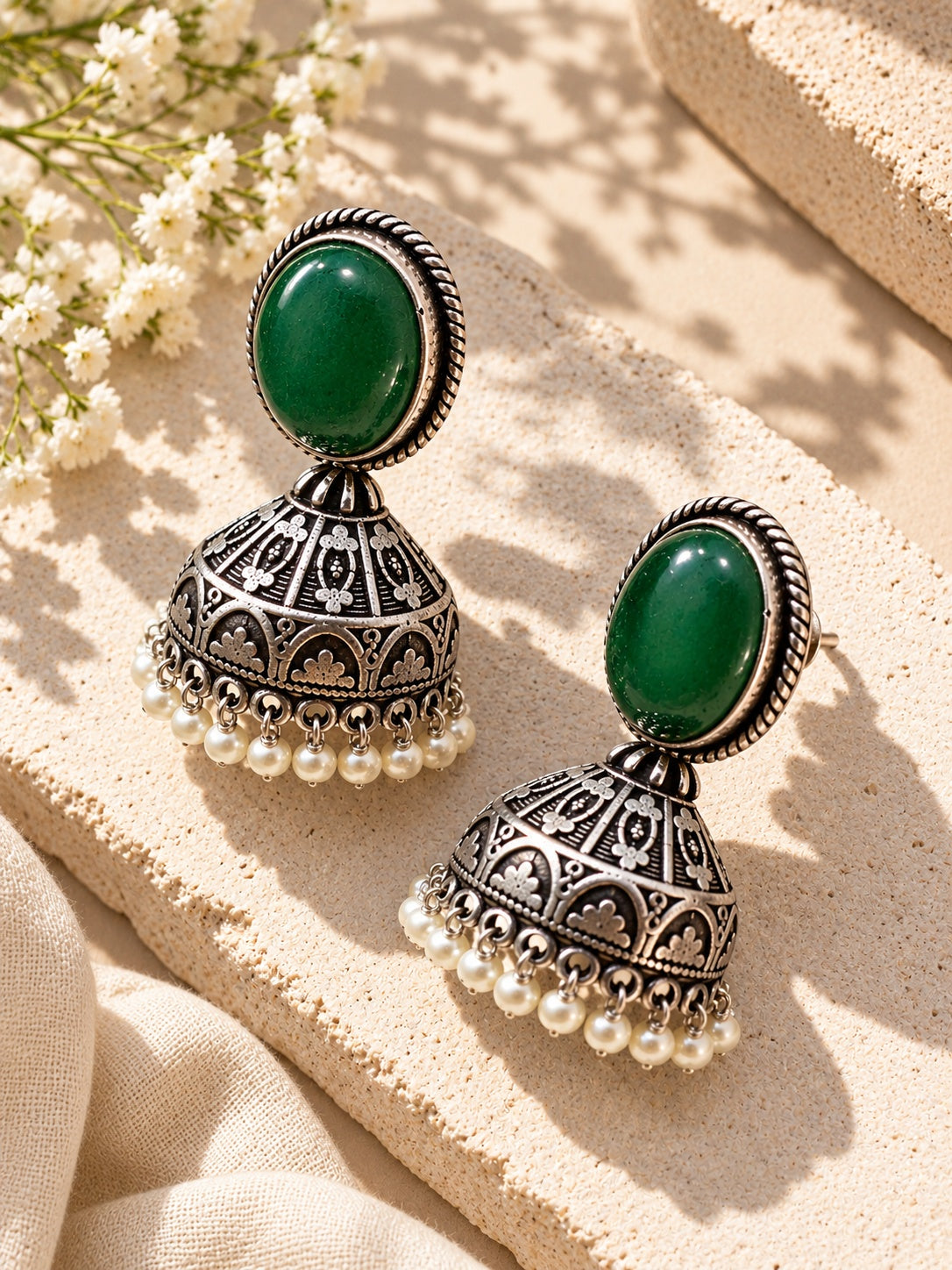 Green stone silver replica jhumka earrings angled view