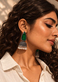 Niska green Monalisa Stone Silver replica jhumka earrings worn with loose curly hair and cream shirt