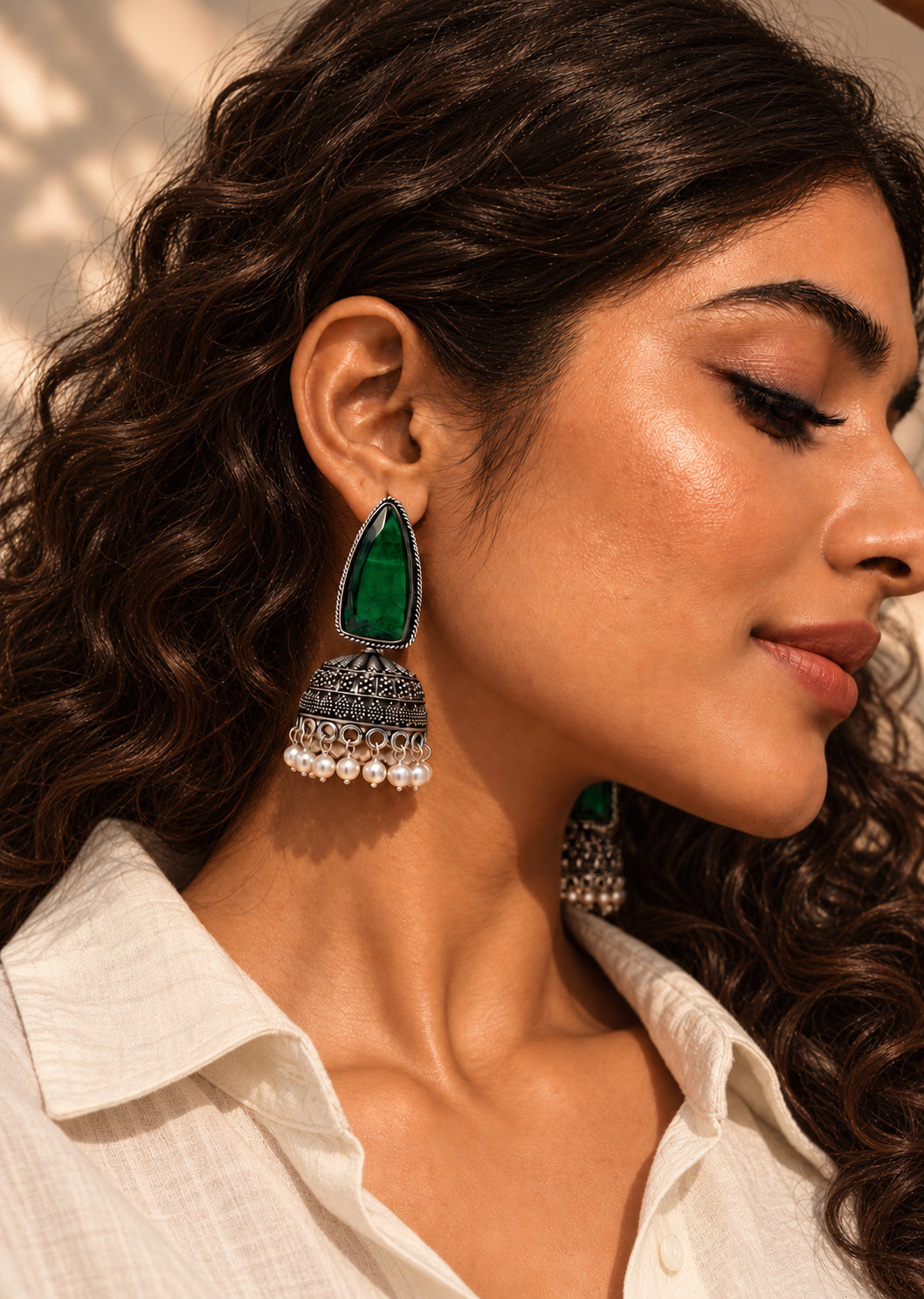 Niska green Monalisa Stone Silver replica jhumka earrings worn with loose curly hair and cream shirt