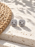 AD Stone Silver Replica floral stud earrings on white travertine