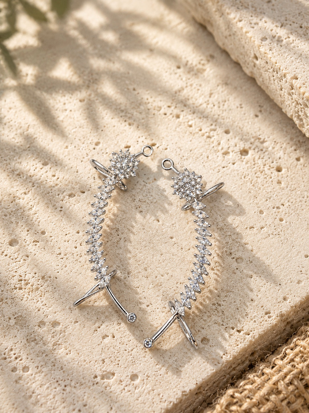 NISKA AD stone silver replica earrings on travertine flat lay