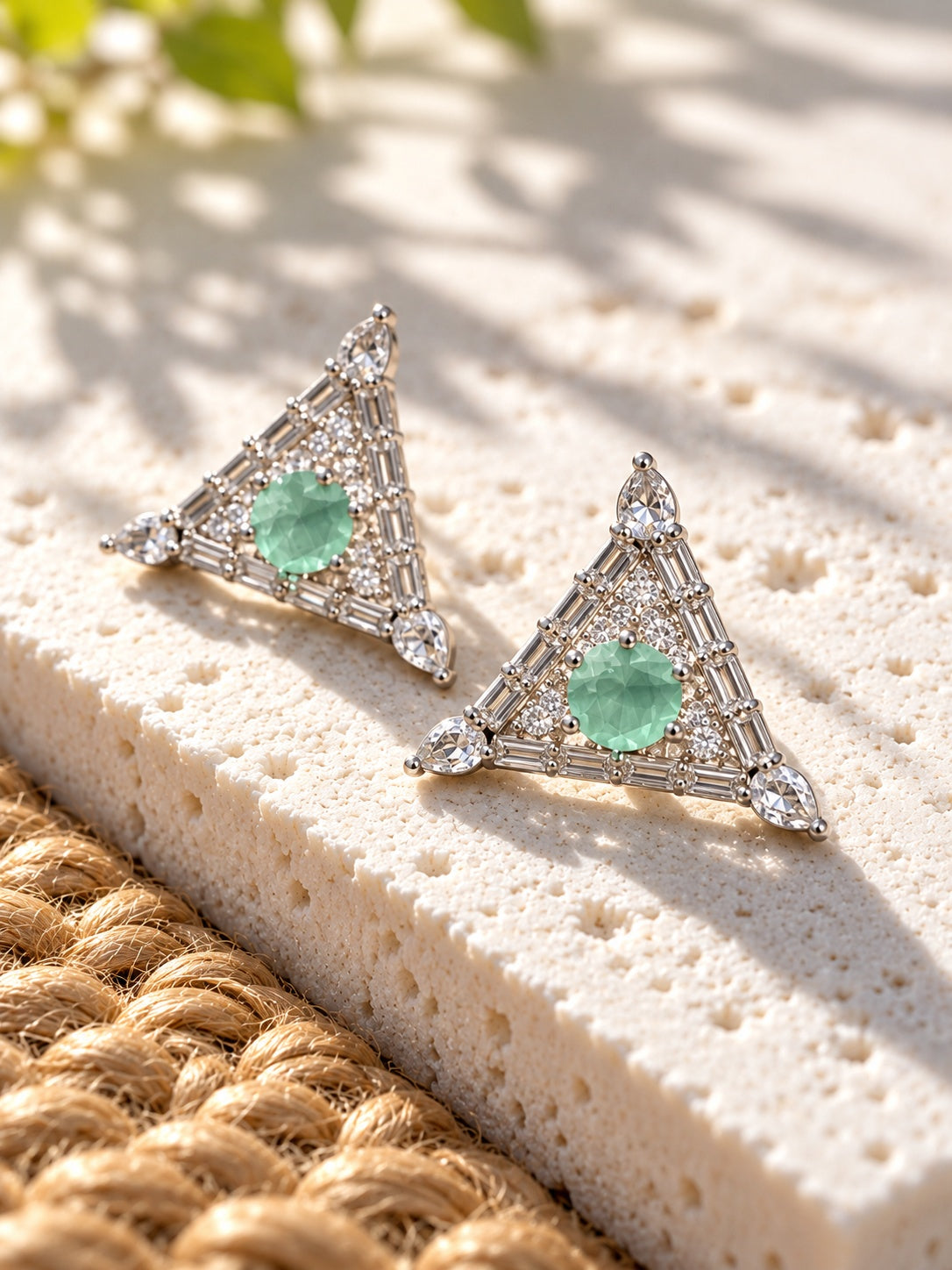 Triangular silver replica earrings with mint green stones angled view