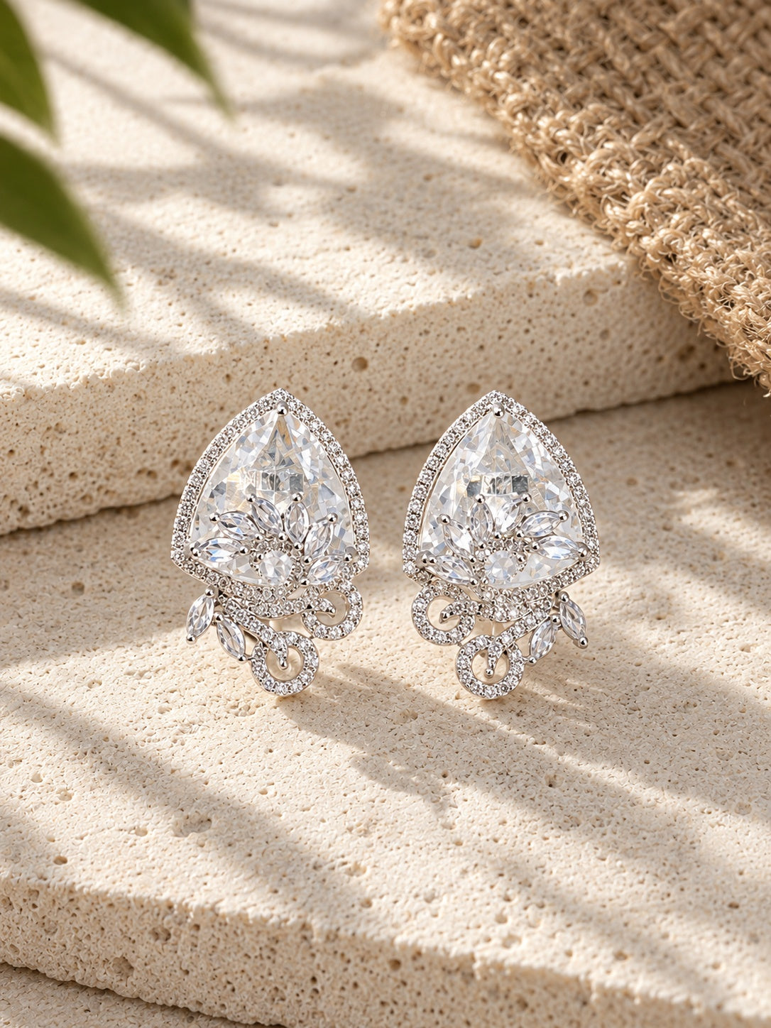 Close-up of silver replica AD stone statement earrings