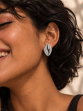 Niska Silver replica AD Stone leaf stud earring worn with black dress