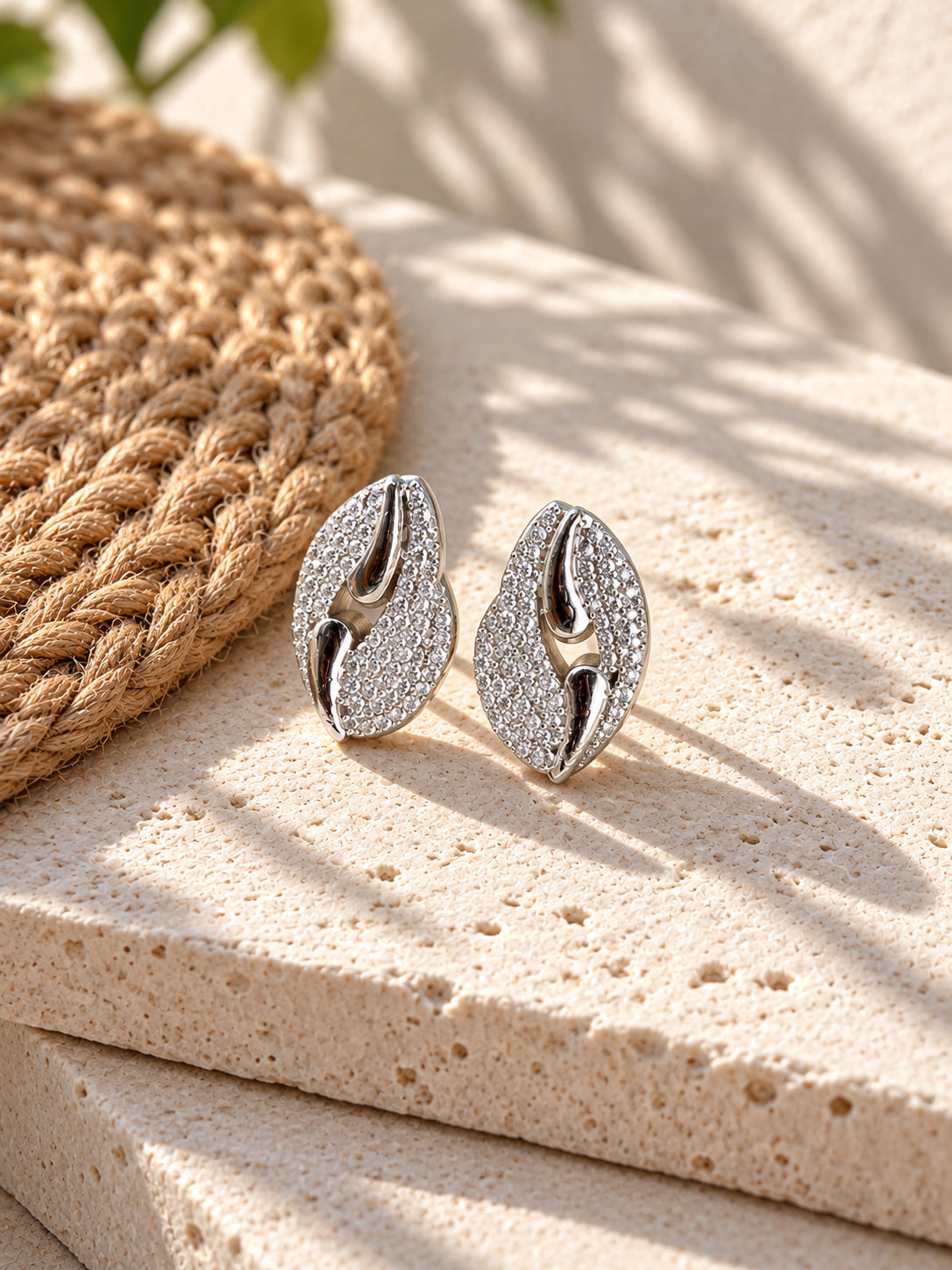 Niska Silver replica AD Stone leaf stud earrings on white travertine view 2