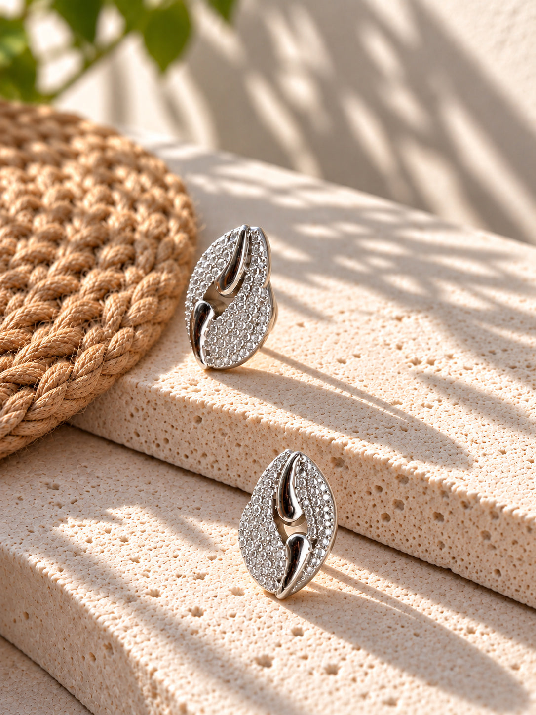Niska Silver replica AD Stone leaf stud earrings on white travertine view 4