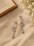 NISKA silver crystal loop drop earrings flat lay angle two