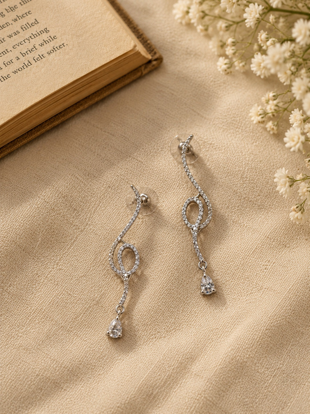 NISKA silver crystal loop drop earrings flat lay angle two