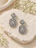 Silver AD stone replica drop earrings editorial flat lay