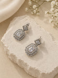 Silver AD stone replica drop earrings on textured stone