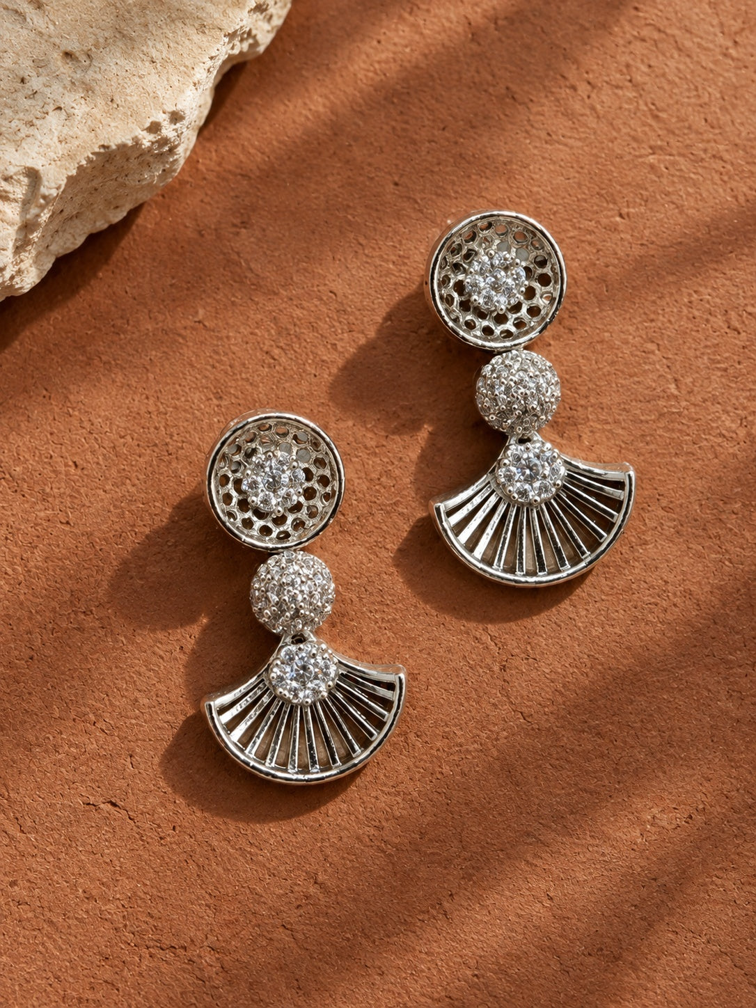 Model wearing NISKA AD Stone silver replica fan drop earrings