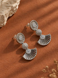 Angled view of silver fan-shaped statement earrings