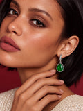 Niska green pear AD Stone Silver replica earrings worn by model in ivory dress