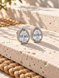 Niska AD Stone Silver Replica pear stud earrings on white travertine, view 2