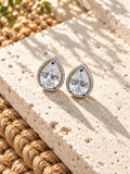 Niska AD Stone Silver Replica pear stud earrings on white travertine, view 3