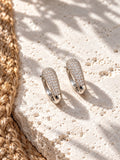 Niska AD Stone Silver Replica Hoop Earrings on white travertine 6