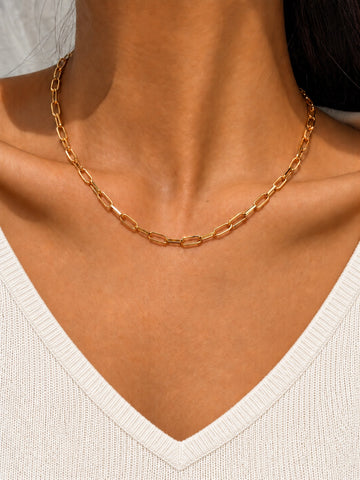 Niska gold-tone paperclip chain necklace replica on model with V-neck top