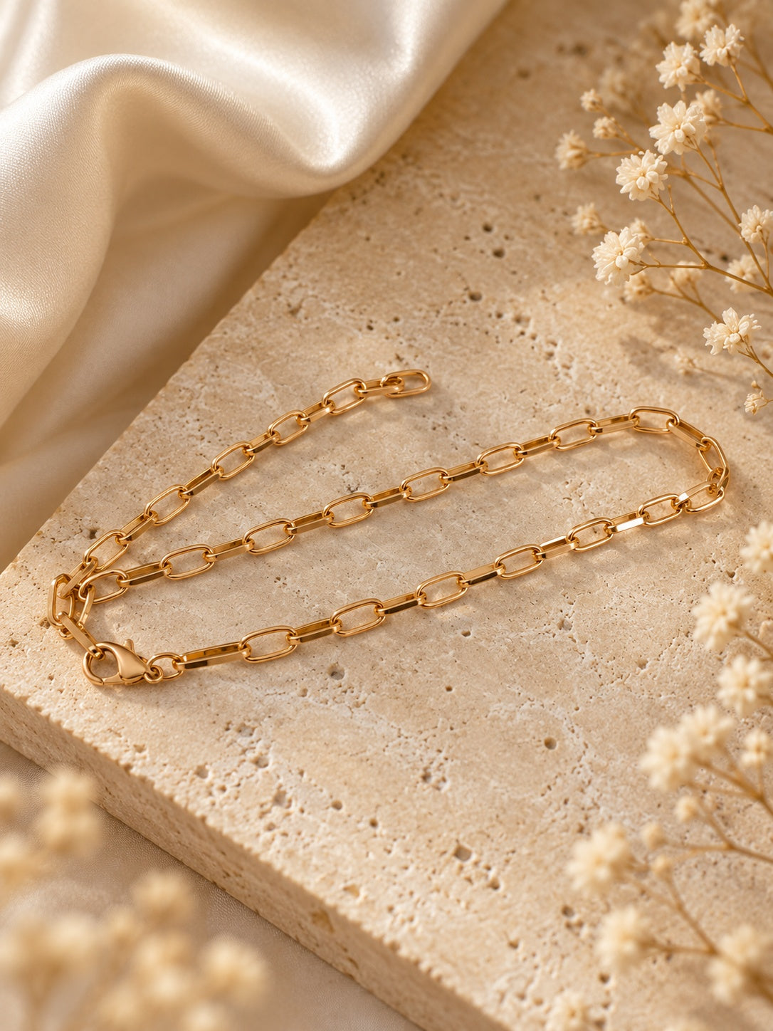 Niska gold-tone paperclip chain necklace replica on model with V-neck top