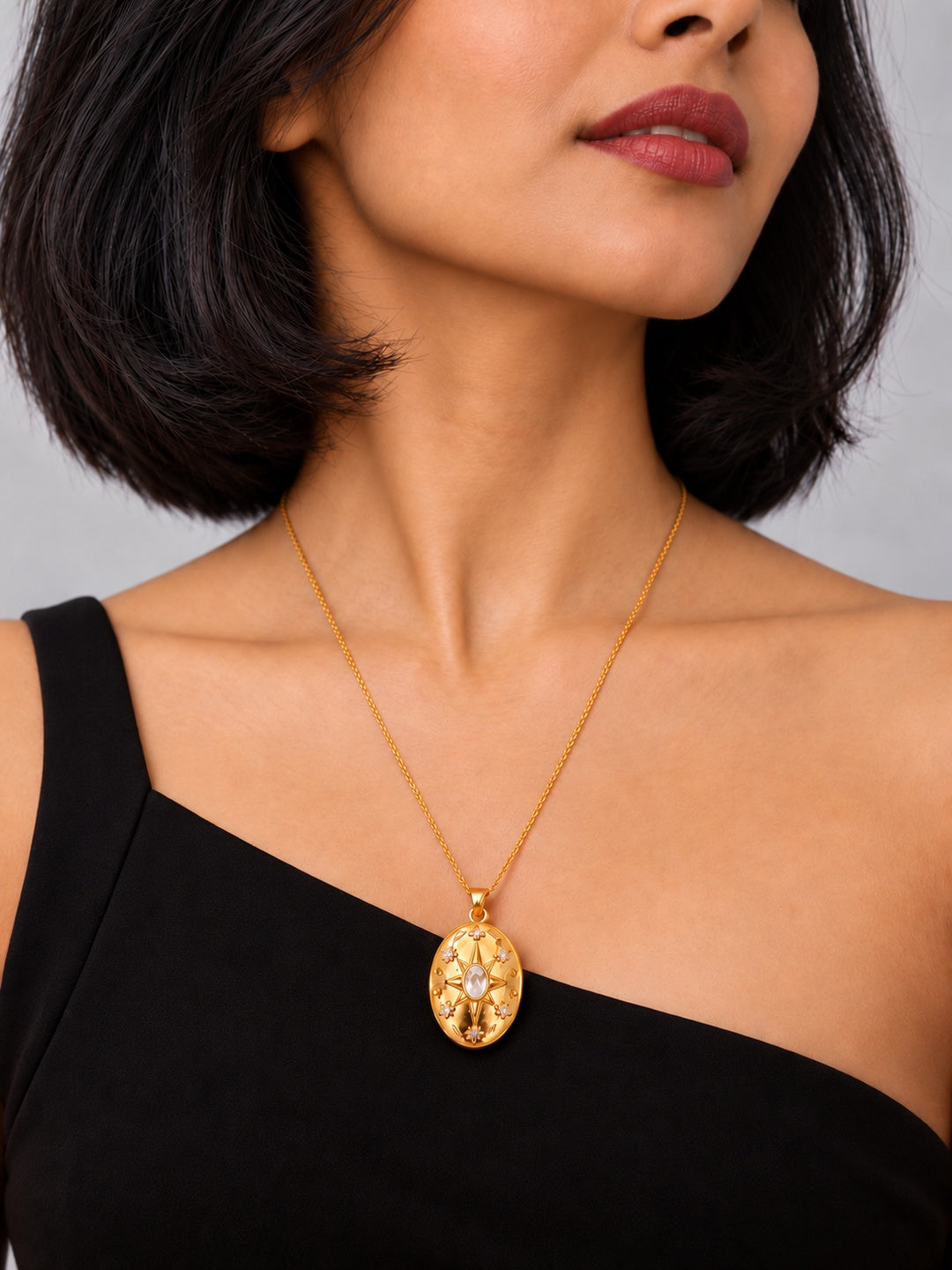 Niska gold-tone celestial oval replica pendant necklace on model