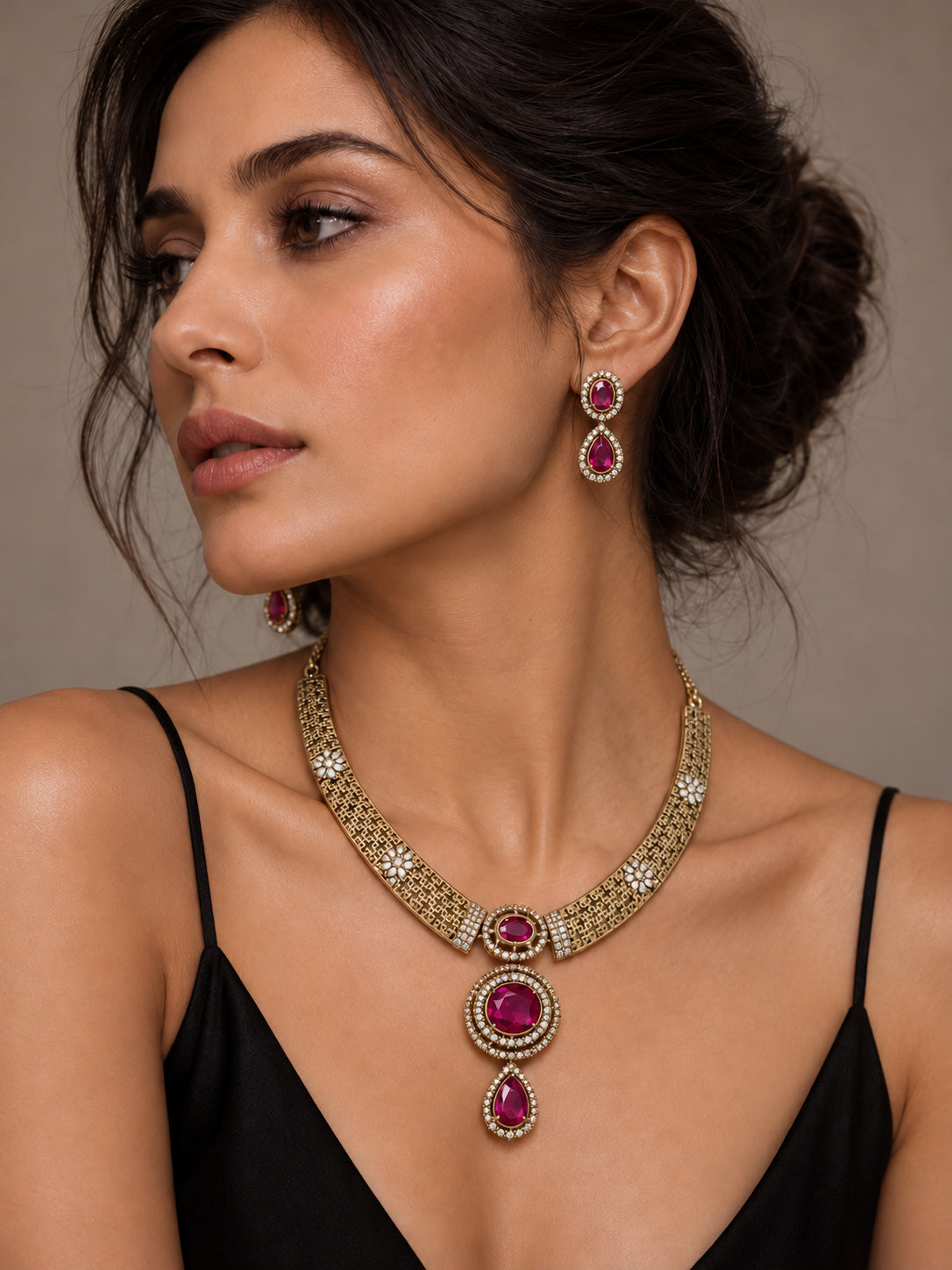 Niska ruby pink gold-tone replica necklace set with matching earrings on model