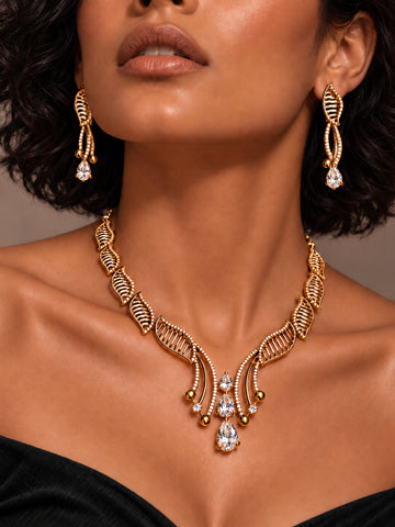 Niska AD stone leaf necklace set with matching earrings — model in black dress
