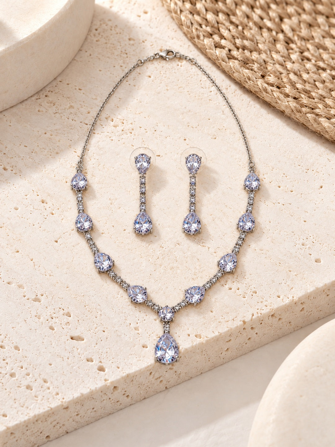 Niska pear drop replica necklace set with matching earrings on model