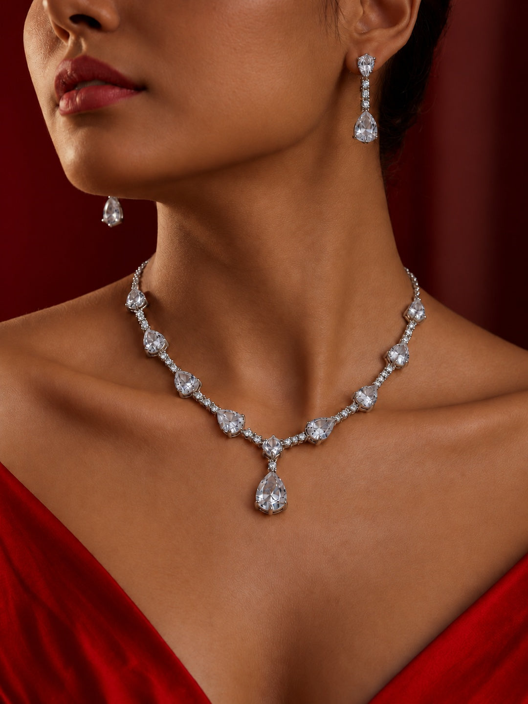 Niska pear drop replica necklace set with matching earrings on model
