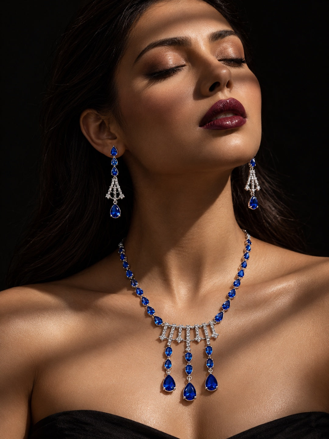Niska blue teardrop replica necklace set with matching earrings on model