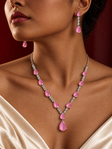 Pink teardrop replica necklace and earrings set worn with ivory satin