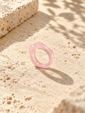 Blush pink sculpted replica ring on sunlit ivory travertine