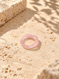 Blush pink sculpted replica ring on sunlit ivory travertine