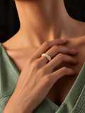 Ivory dome replica ring worn on hand with sage green dress