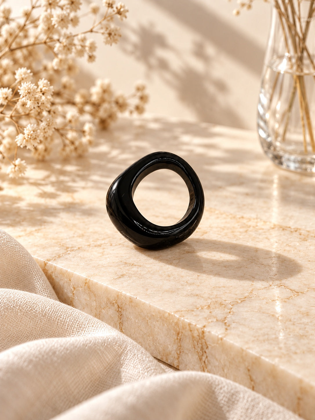 Niska glossy black statement replica ring worn on model hand