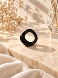 Niska glossy black statement replica ring on cream marble