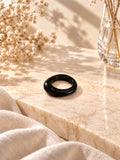 Niska glossy black statement replica ring on cream marble