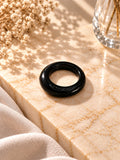Niska glossy black statement replica ring on cream marble